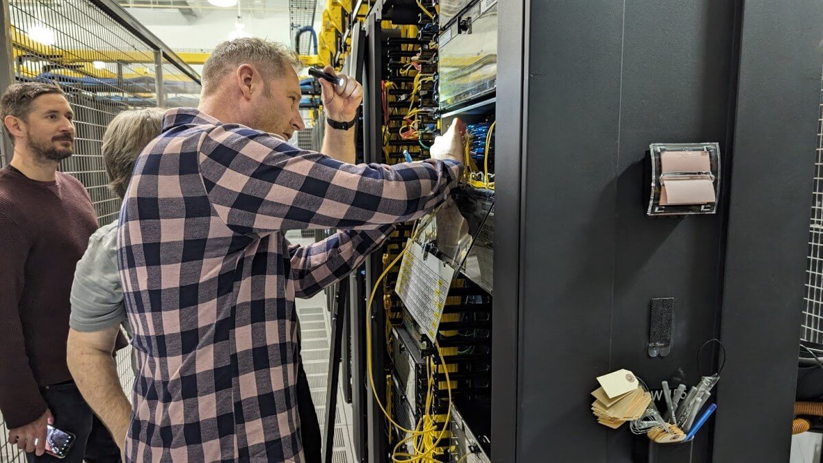 Summit CEO Warren Patterson is taking a hands-on approach - At a Deft data center, shown alongside Deft engineers.